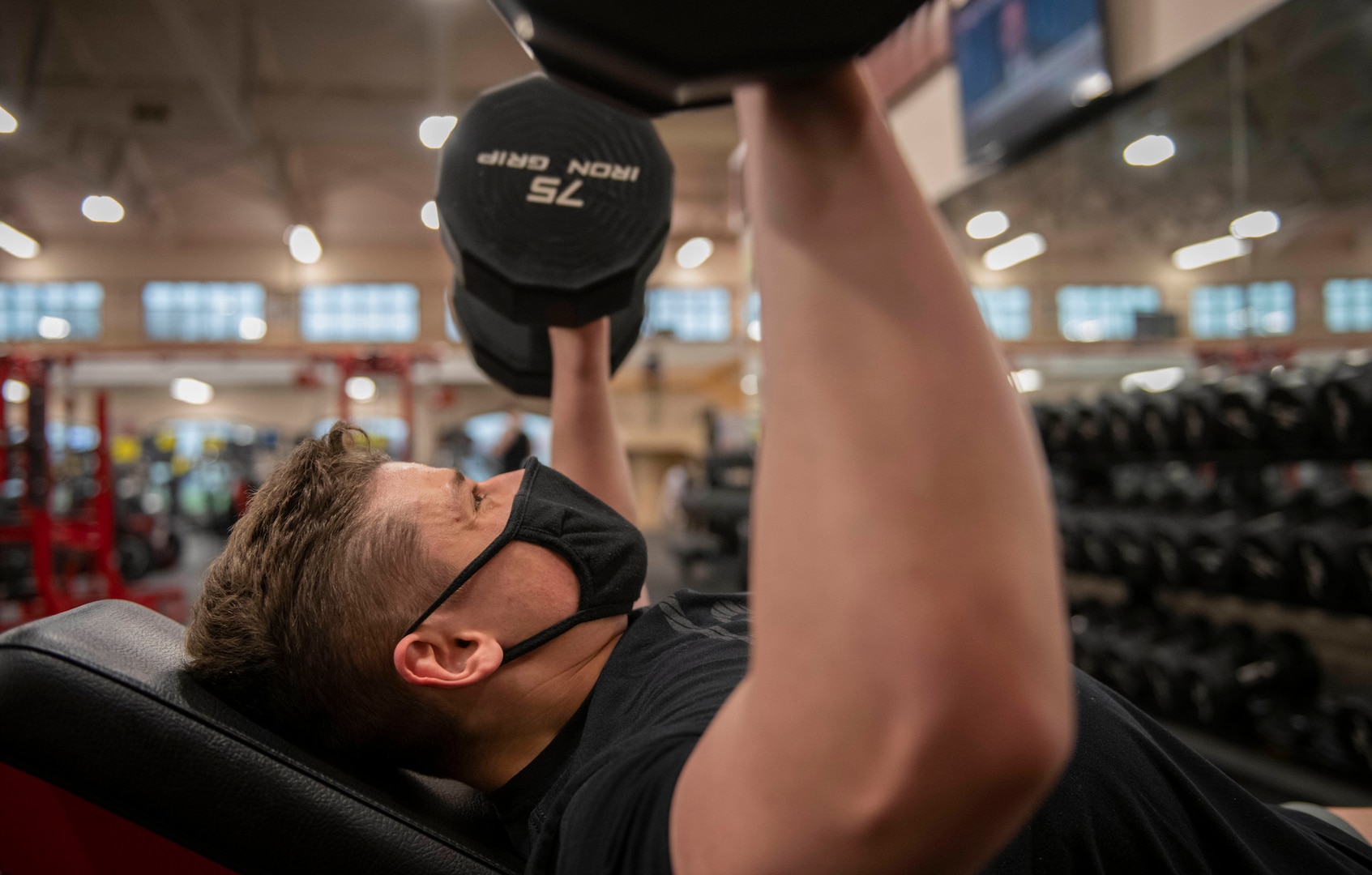 Airman 1st Class Isaac Olivera, 375th Air Mobility Wing mass communicator, pushes weights at the Rambler Fitness Center.