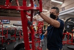 Armando Torres, 502nd Force Support Squadron recreational aide, cleans exercise equipment at Rambler Fitness Center.