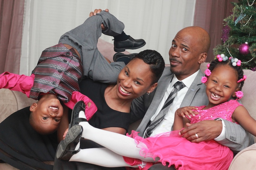 A man, woman and two children pose for a photo.