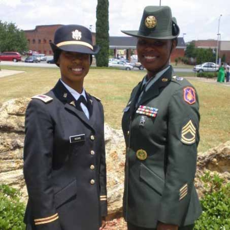 Two soldiers pose for a photo.