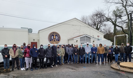 Sailors from Mobile Diving and Salvage Unit 2 pose for a photo, before departing for New York.  MDSU personnel will provide support to FEMA and the national vaccination effort at a site in Queens, NY.