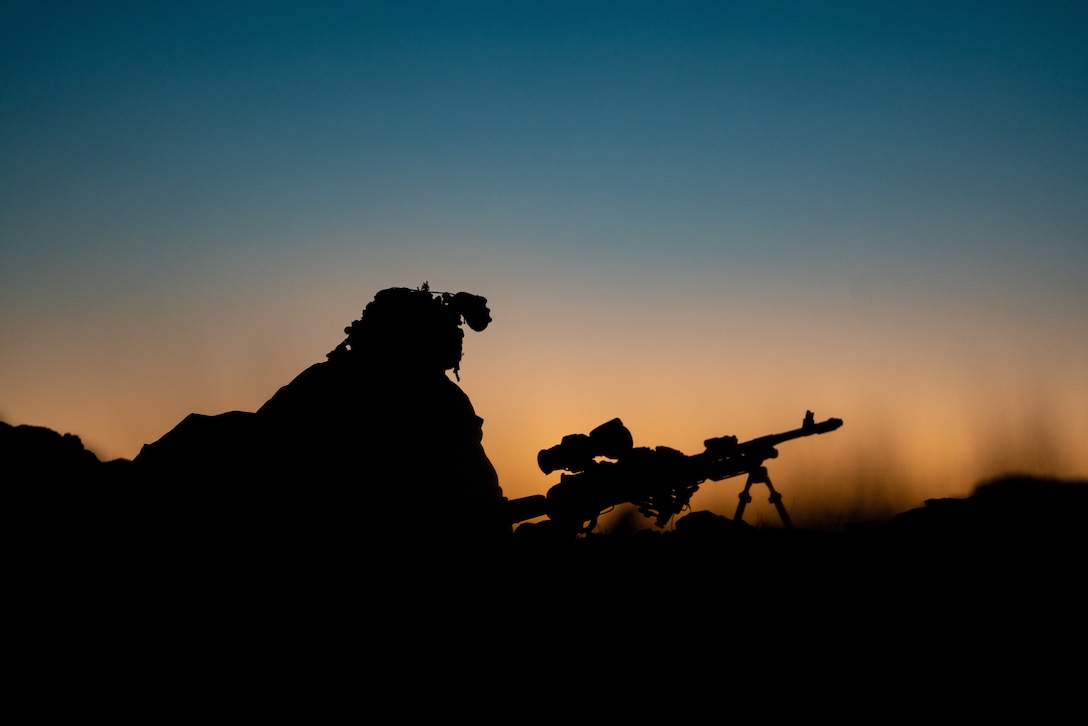 A Marine holds security with an M240B Medium Machine Gun while defending a checkpoint at the Marine Corps Air Ground Combat Center, Twentynine Palms, Feb,17.