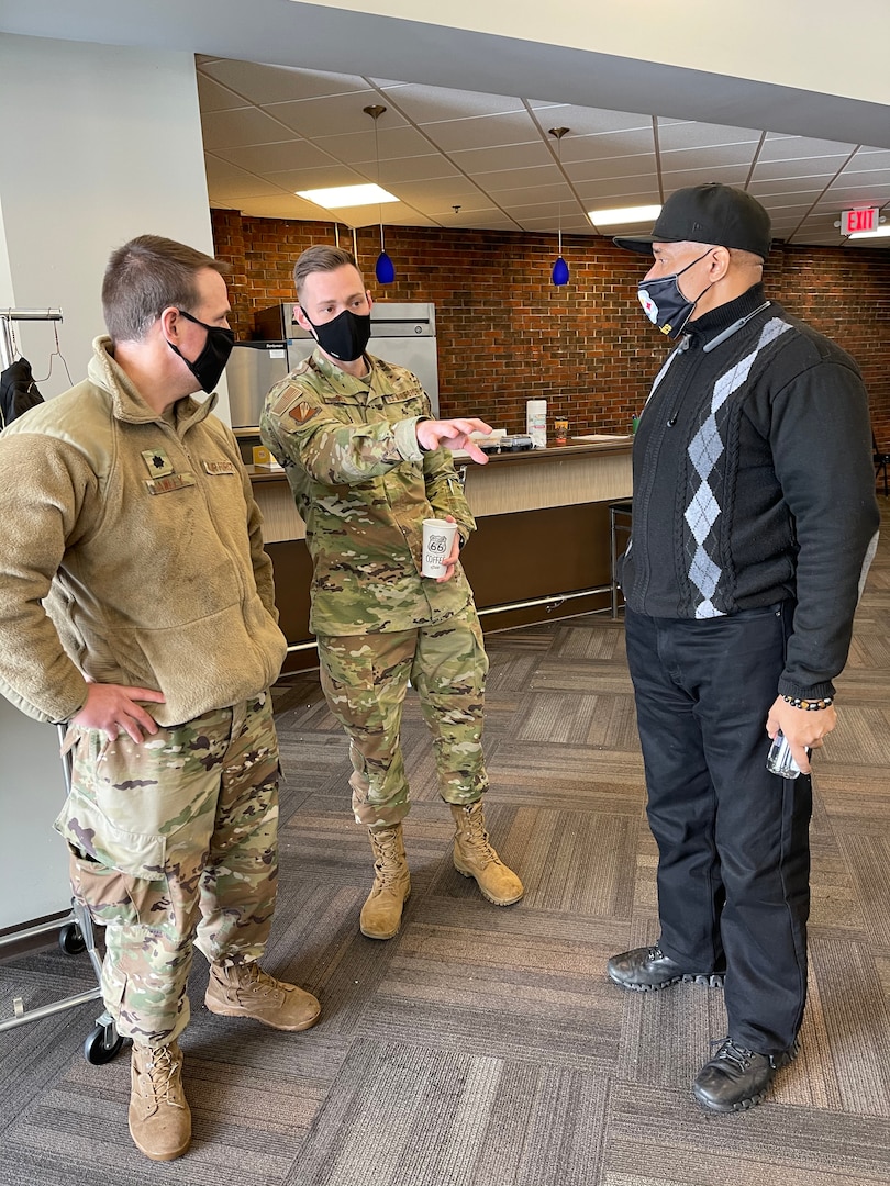 Missouri Air National Guard Lt. Col Glen Hawley (left) and Capt. Tony Rich (middle) discuss operations at a Targeted Vaccination Team event with James Clark, Vice President of Public Safety and Community Response, Urban League of St. Louis (right)