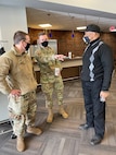 Missouri Air National Guard Lt. Col Glen Hawley (left) and Capt. Tony Rich (middle) discuss operations at a Targeted Vaccination Team event with James Clark, Vice President of Public Safety and Community Response, Urban League of St. Louis (right)