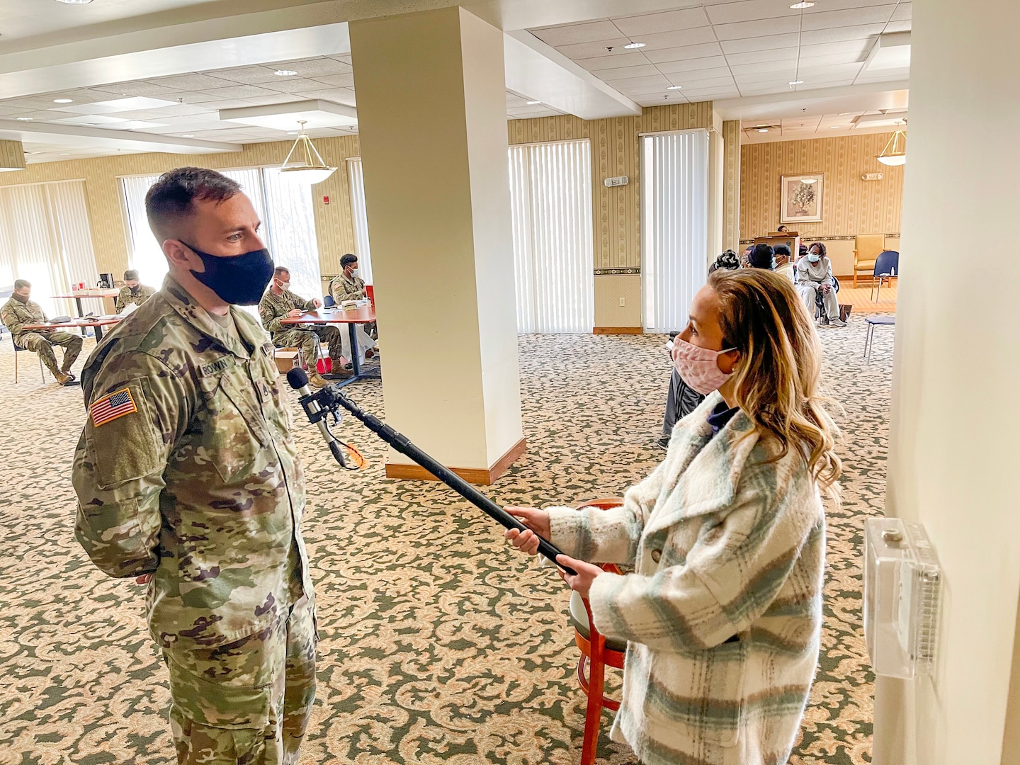 Missouri Army National Guard Staff Sgt. Jeremy Brown, 1107th TASMG, being interviewed by Emma Hogg of KMOV at a targeted vaccination team site in St. Louis on February 24, 2021.