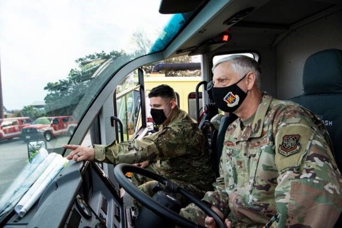 Senior Airman Joseph Passariello, 628th Civil Engineer Squadron firefighter shows Maj. Gen. Mark Camerer, U.S. Air Force Expeditionary Center commander, one of their vehicles at Joint Base Charleston, S.C., Feb. 9, 2021. Camerer, along with Chief Master Sgt. Anthony W. Green, USAF Expeditionary Center command chief, toured the base to get a firsthand look at Team Charleston’s capabilities and accomplishments.