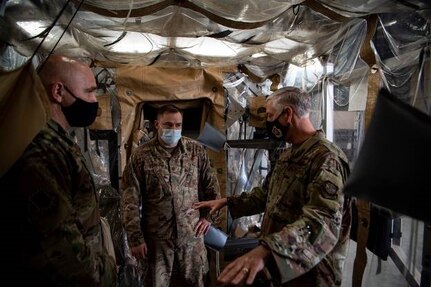 Maj. Ben Weaver, 628th Operational Medical Readiness Squadron Bioenvironmental Engineering flight commander, listens as Maj. Gen. Mark Camerer, U.S. Air Force Expeditionary Center commander, asks a question about the Transport Isolation System at Joint Base Charleston, S.C., Feb. 9, 2021. Camerer, along with Chief Master Sgt. Anthony W. Green, USAF Expeditionary Center command chief, toured the base to get a firsthand look at Team Charleston’s capabilities and accomplishments.