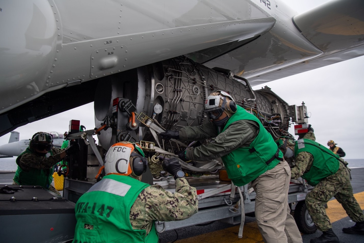 Sailors with the “Argonauts” of Strike Fighter Squadron (VFA) 147 load an F-35C Lightning II engine module onto a CMV-22B Osprey with the “Titans” Fleet Logistics Multi-Mission Squadron (VRM) 30 on the flight deck of Nimitz-class nuclear aircraft carrier USS Carl Vinson (CVN 70). Vinson is currently underway conducting routine maritime operations.