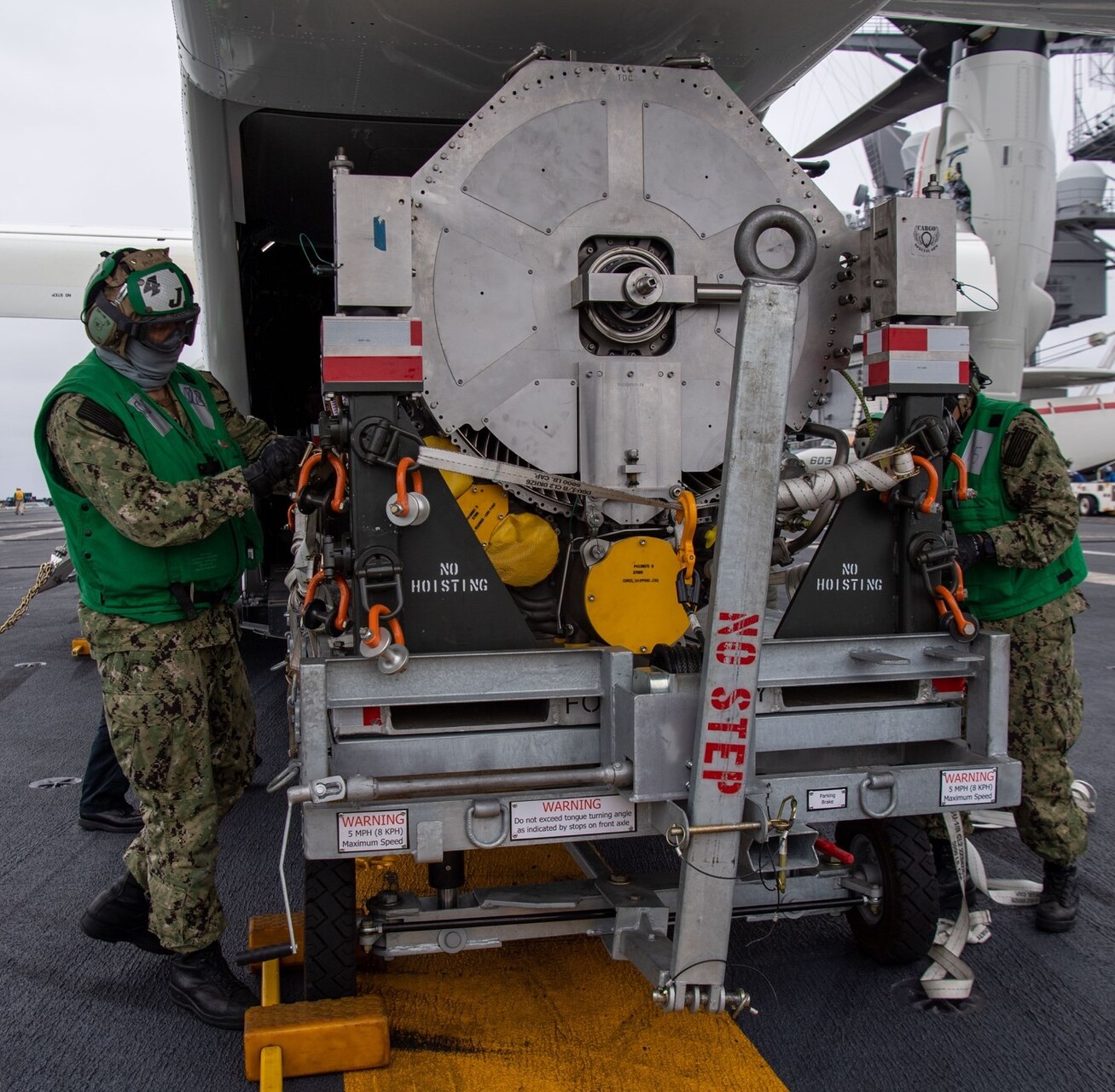 Sailors with the “Argonauts” of Strike Fighter Squadron (VFA) 147 load an F-35C Lightning II engine module onto a CMV-22B Osprey with the “Titans” Fleet Logistics Multi-Mission Squadron (VRM) 30 on the flight deck of Nimitz-class nuclear aircraft carrier USS Carl Vinson (CVN 70). Vinson is currently underway conducting routine maritime operations.