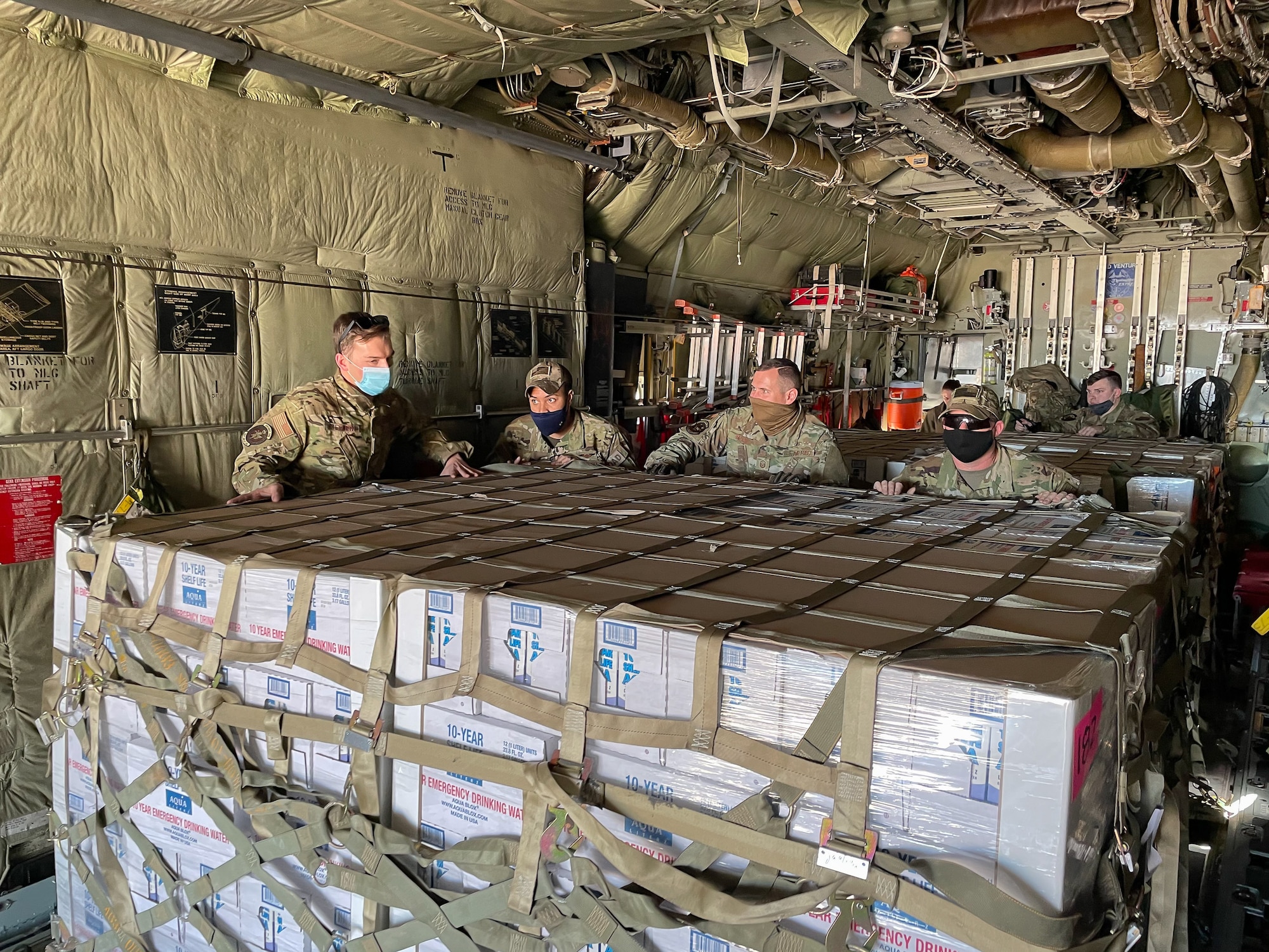 Airmen from the Kentucky Air National Guard deliver relief supplies to Abilene, Texas Feb. 23, 2021,  following a winter storm that left millions without electricity or potable water for days. The supplies, flown aboard a C-130 Hercules aircraft from the Louisville, Kentucky-based 123rd Airlift Wing, include food and bottled water. (U.S. Air National Guard photo)