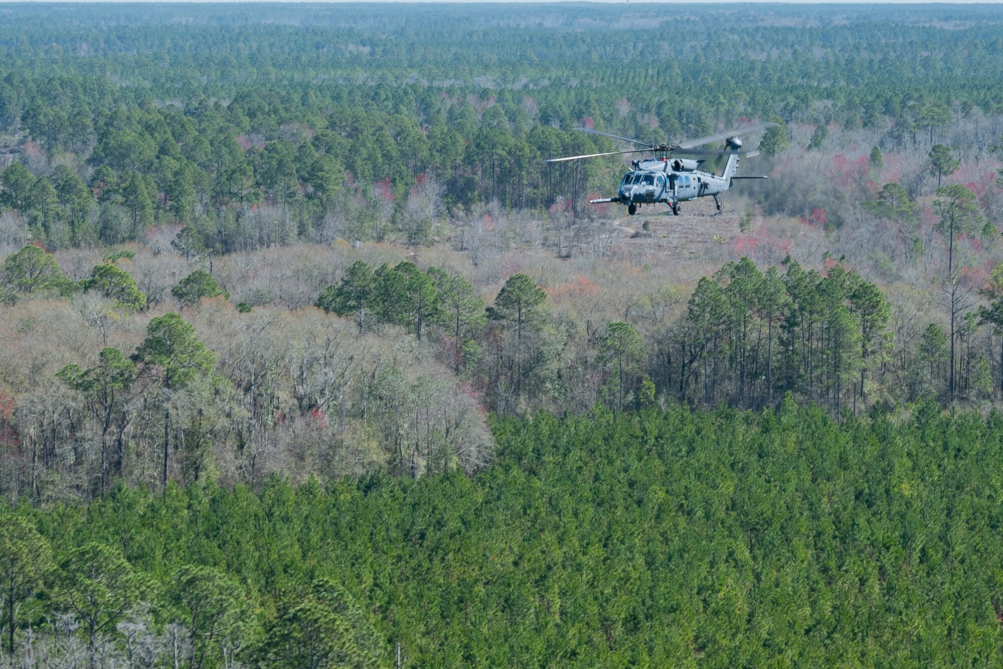 Photo of an HH-60W Jolly Green II flying after a simulated rescue mission