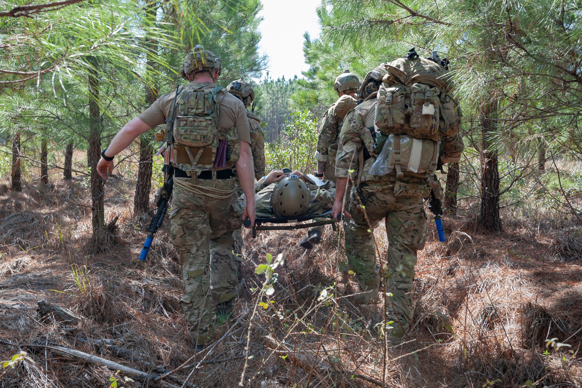 Photo of Airmen carrying a simulated wounded Airman