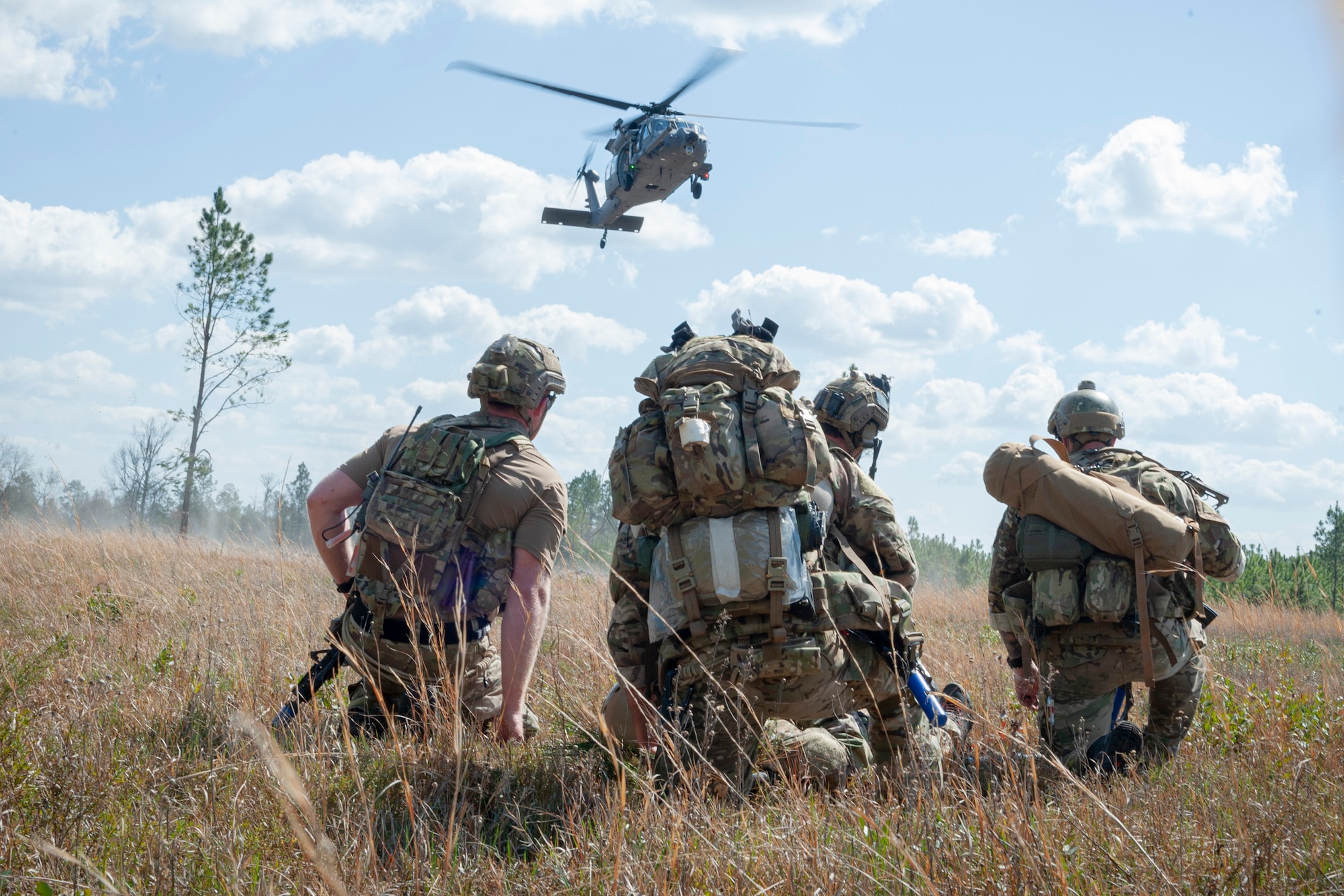 Photo of Airmen preparing to transport a simulated wounded Airman