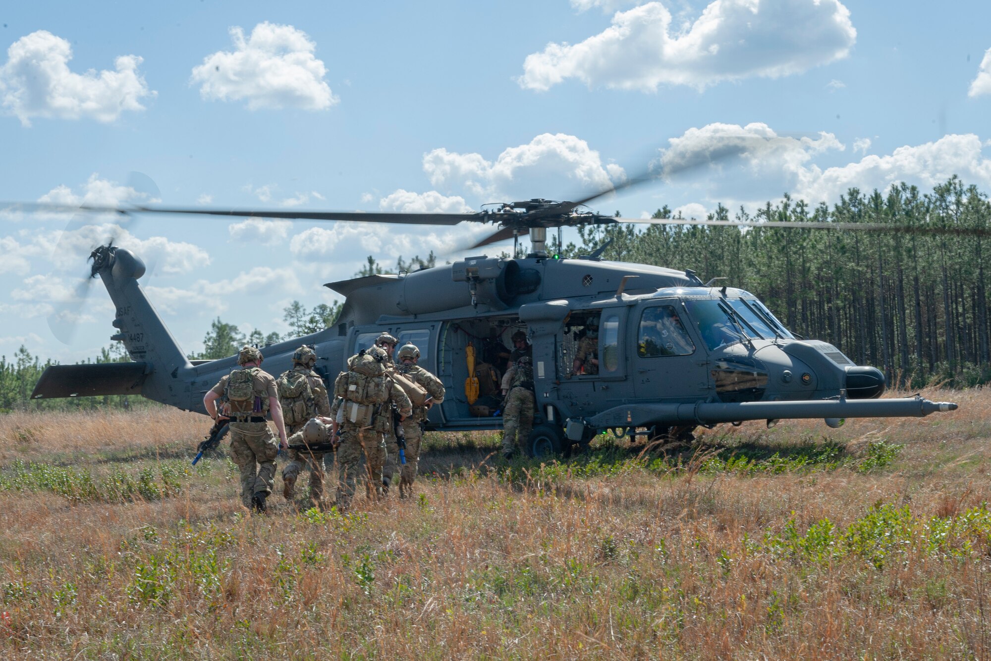 Photo of Airmen transporting a simulated wounded Airman
