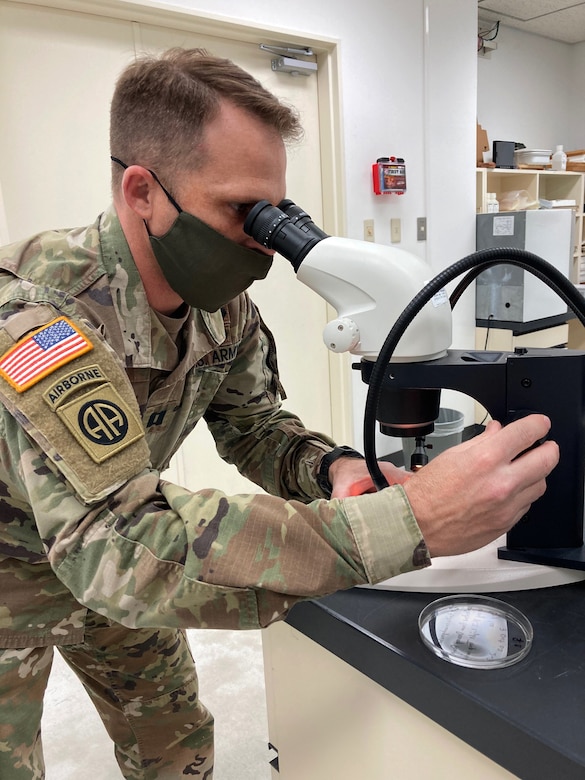 Capt. John Eads, chief of entomology for Public Health Command-Pacific in Japan, examines a vector sample in a microscope at Camp Zama, Japan, Feb. 25, 2021. This spring, Eads and his team will launch the first ever Pre-Exercise Vector Surveillance program for the Indo-Pacific region.