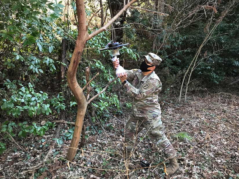 Staff Sgt. Matthew Pascual, noncommissioned officer in charge of entomology for Public Health Command-Pacific in Japan, collects mosquito specimens from a surveillance light trap to test for vector-borne pathogens of human concern on Camp Zama, Japan, Feb. 25, 2021. Collecting vector samples allows for PHC-P scientists to analyze areas of interest for potential vector-borne diseases that could impact the health of the force.