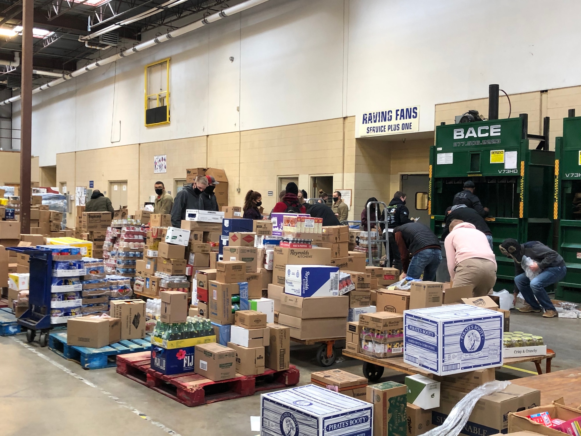 Volunteers retrieve groceries from pallets in the commissary on Goodfellow Air Force Base, Texas, Feb. 17, 2021. Volunteers arrived in large numbers to assist the commissary staff in restocking their shelves. (Courtesy photo)