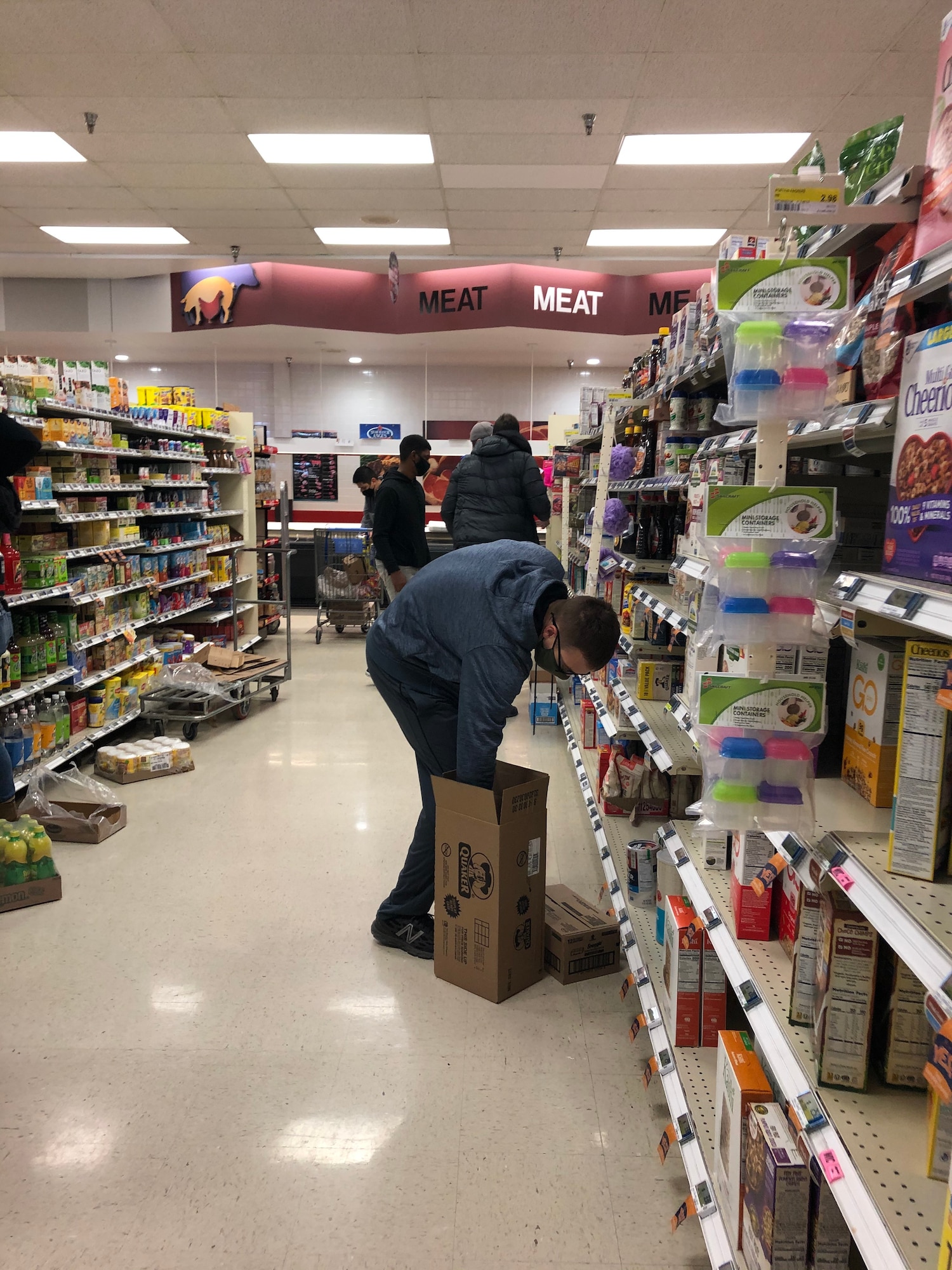 A Goodfellow volunteer stocks shelves in the commissary on Goodfellow Air Force Base, Texas, Feb. 17, 2021. Roughly 100 volunteers stocked thousands of items in less than an hour to assist commissary staff with the increased demand from Winter Storm Uri. (Courtesy photo)