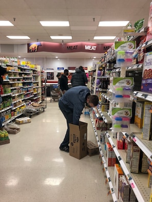 A Goodfellow volunteer stocks shelves in the commissary on Goodfellow Air Force Base, Texas, Feb. 17, 2021. Roughly 100 volunteers stocked thousands of items in less than an hour to assist commissary staff with the increased demand from Winter Storm Uri. (Courtesy photo)