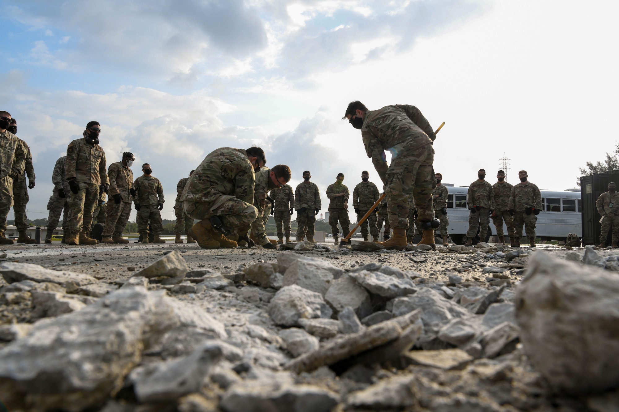 U.S. service members from the 18th Wing demonstrate expedient spall-repair knowledge during a Multi-Capable Airmen course exercise, at Kadena Air Base, Japan, Feb. 25, 2021. The MCA course, the first of its kind at Kadena, includes classroom education but distinctly focuses on hands-on training.