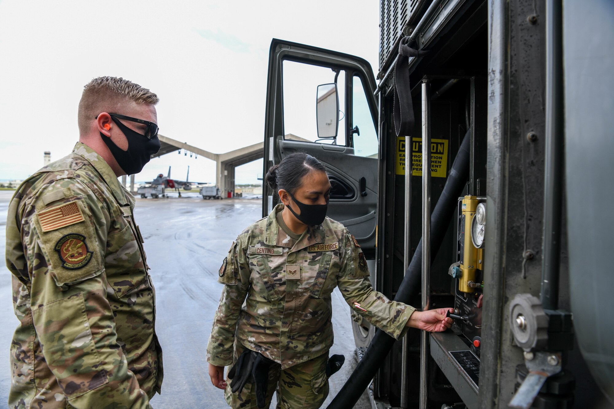 U.S. Air Force Tech Sgt. Chaz Wise, a quality assurance evaluator from the 18th Logistic Readiness Squadron, instructs Senior Airman Jamaila Centino, a member from the 18th Wing Security Forces Squadron, on refueling procedures during a Multi-Capable Airmen course exercise on Kadena Air Base, Japan, Feb. 26, 2021. The MCA course is conducted over five days, and includes three tiers of training, each more in-depth than the last.