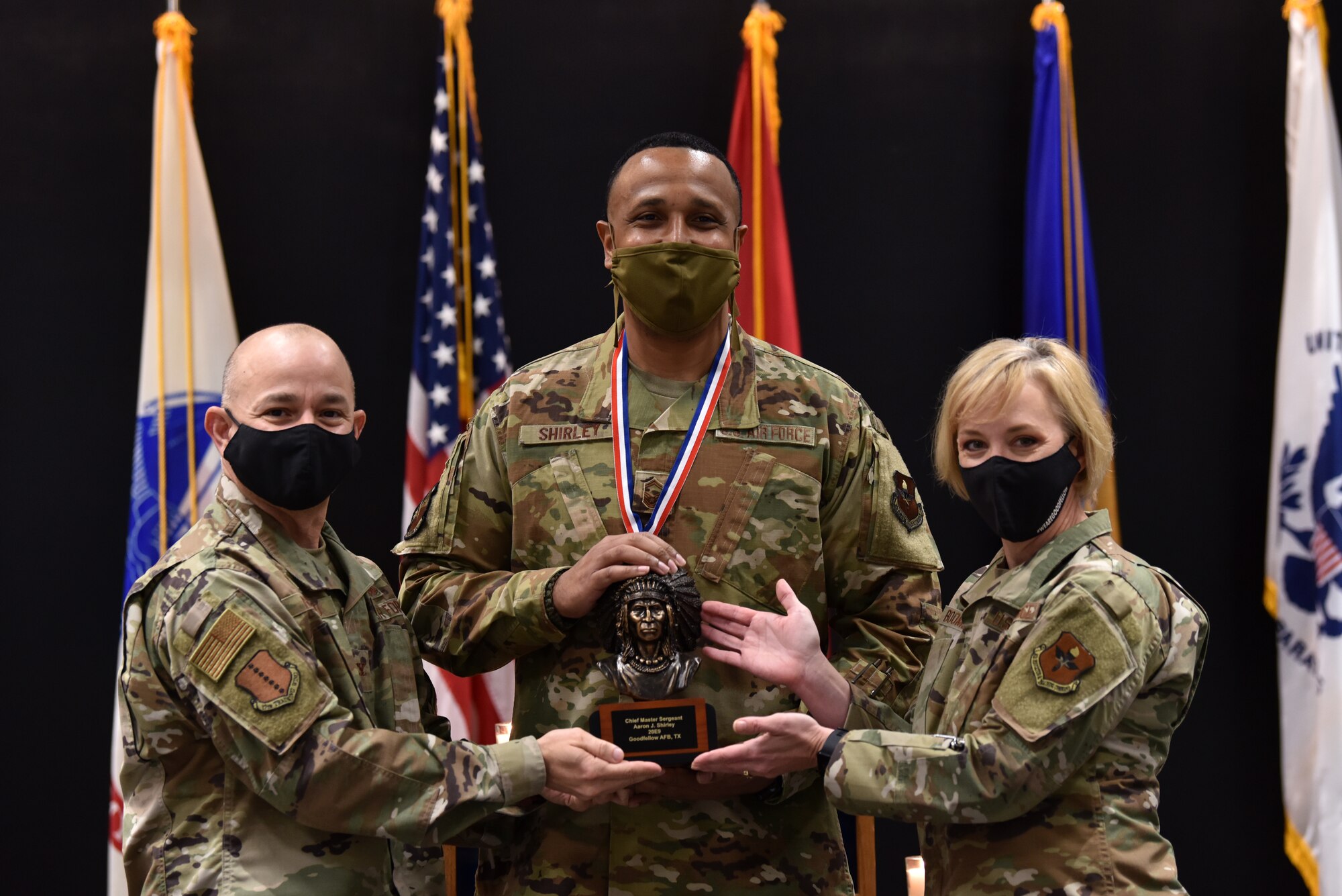 U.S. Air Force Col. Andres Nazario, 17th Training Wing commander, and Chief Master Sgt. Casy Boomershine, 17th Training Wing command chief, present Chief Master Sgt. select Aaron Shirley, 316th Training Squadron operations superintendent with an award, formally recognizing him as one of the newest chief master sergeant selects in the Air Force. (U.S. Air Force photo by Staff Sgt. Seraiah Wolf)