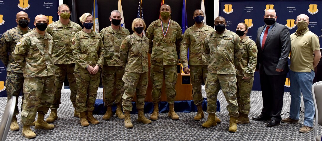 U.S. Air Force Chief Master Sgt. select Aaron Shirley, 316th Training Squadron operations superintendent, stands with active duty and retired E-9s from the Air Force and sister services during the induction ceremony at the Event Center on Goodfellow Air Force Base, Texas, Feb. 25, 2021. Only 1 percent of the enlisted structure in the Air Force are chief master sergeants. (U.S. Air Force photo by Staff Sgt. Seraiah Wolf)