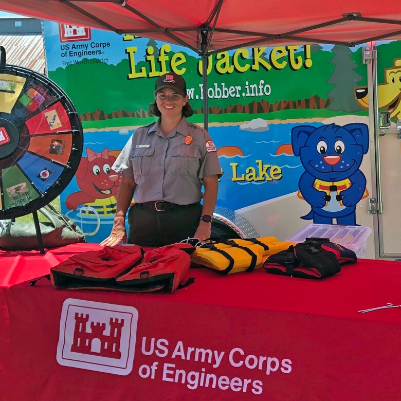 Park ranger stands in water safety booth