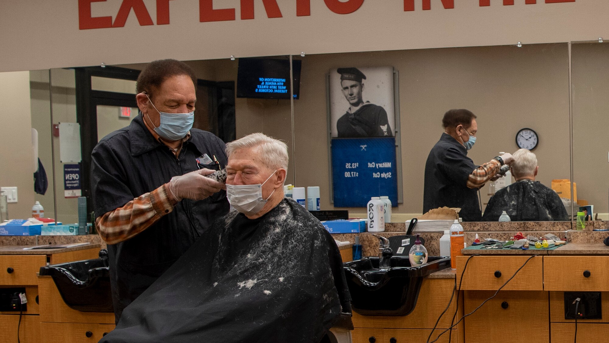 Richard Roe cuts the hair of a customer Feb. 5 at the Wright-Patterson Air Force Base Barber Shop. Meeting new people and being around the Air Force has kept him coming back to work for more than four decades, he says. (U.S. Air Force photo/Airman 1st Class Alexandria Fulton)