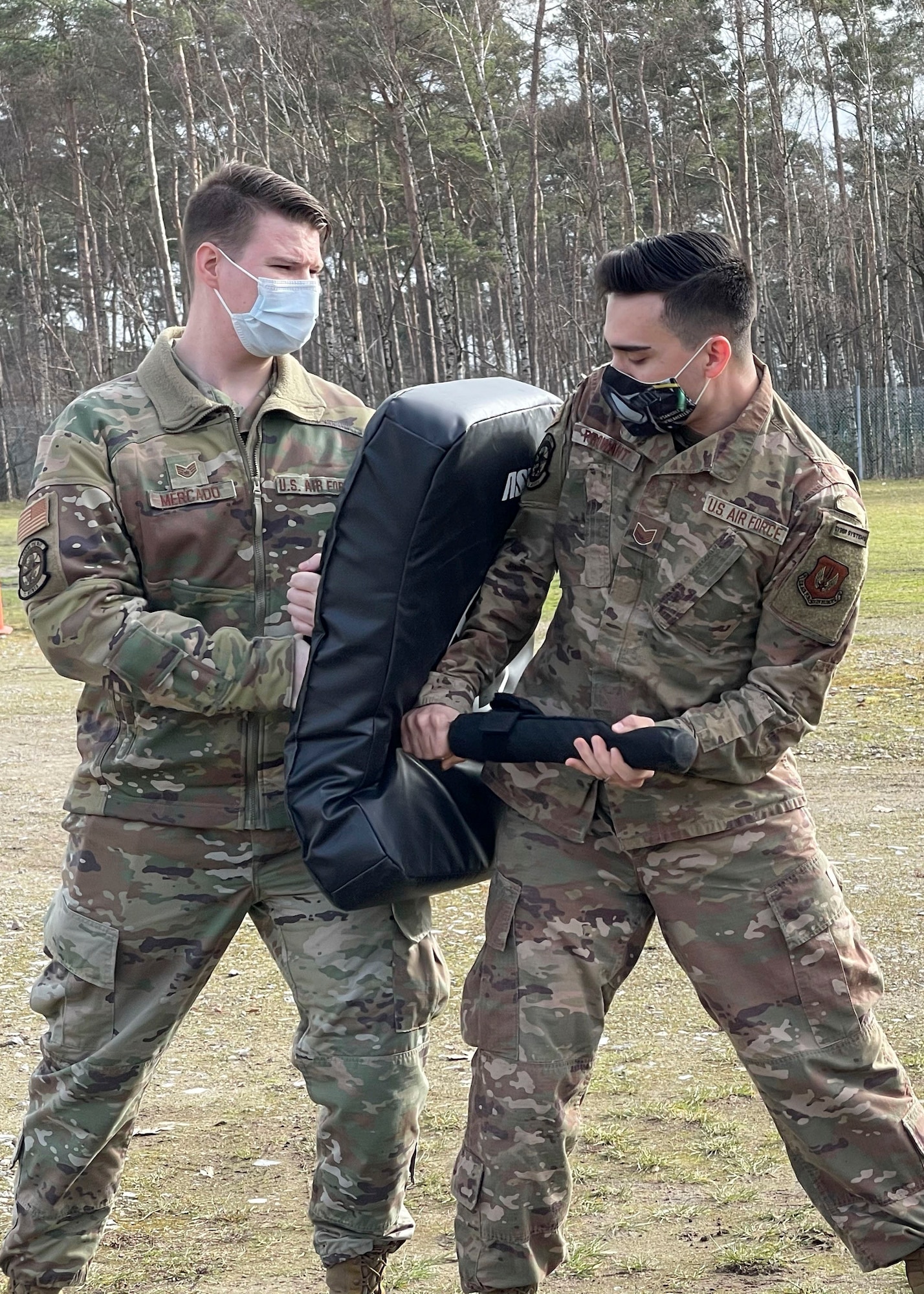 U.S. Air Force Staff Sgt. Brent Mercado, 701st Munitions Support Squadron custody forces specialist, left, and Tech. Sgt. Tyler Prowant, 701st MUNSS NCO in charge of cyber systems, participate in security forces augmentee training at Kleine Brogel Air Base, Belgium, Feb. 26, 2021. Kleine Brogel AB hosts augmentee training every quarter to maintain mission readiness and enhance capabilities amongst Airmen. (Courtesy photo)