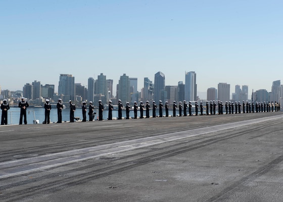 Sailors man the rails on the flight deck of the aircraft carrier USS Nimitz (CVN 68). Nimitz, part of Nimitz Carrier Strike Group, returned to Naval Base San Diego after a more than 10-month deployment.