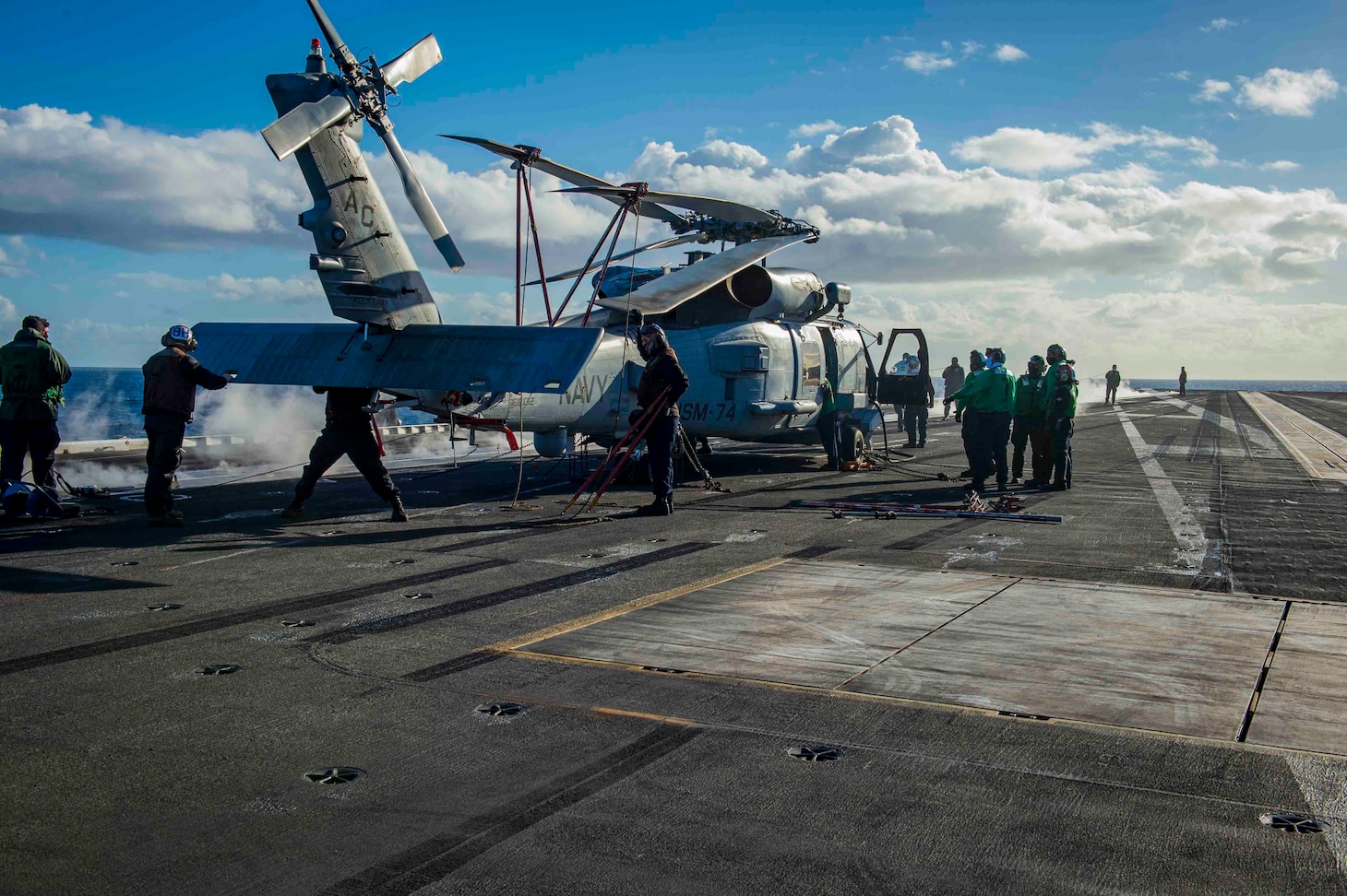 210228-N-OB471-1071 ATLANTIC OCEAN (Feb. 28, 2021) Sailors perform maintenance on an MH-60R Sea Hawk, attached to the "Swamp Foxes" of Helicopter Maritime Strike Squadron (HSM) 74, aboard the Nimitz-class aircraft carrier USS Dwight D. Eisenhower (CVN 69), in the Atlantic Ocean, February 28, 2021. Ike is on a routine deployment supporting U.S. national security interests in Europe and increasing theater cooperation and forward naval presence in the U.S. 6th fleet area of operations. (U.S. Navy photo by Mass Communication Specialist Seaman Jacob Hilgendorf/Released)