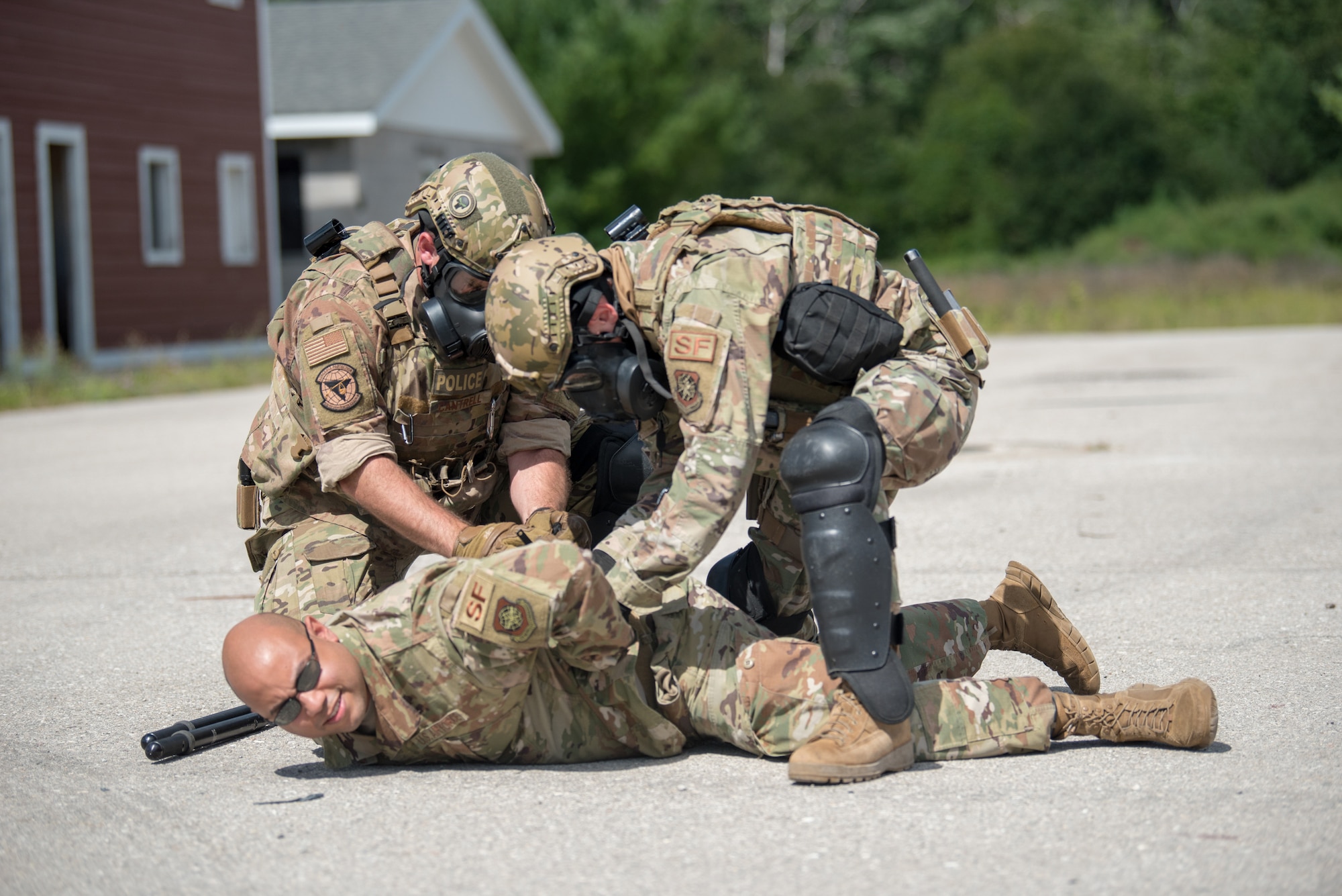 Members of the Kentucky Air National Guard’s 123rd Security Forces Squadron restrain an Airman during a simulated riot in Alpena, Mich., Aug 19, 2020. The Airmen spent a week at Alpena Combat Readiness Training Center to prepare them for domestic operations and law enforcement assistance. (U.S. Air National Guard photo by Phil Speck)