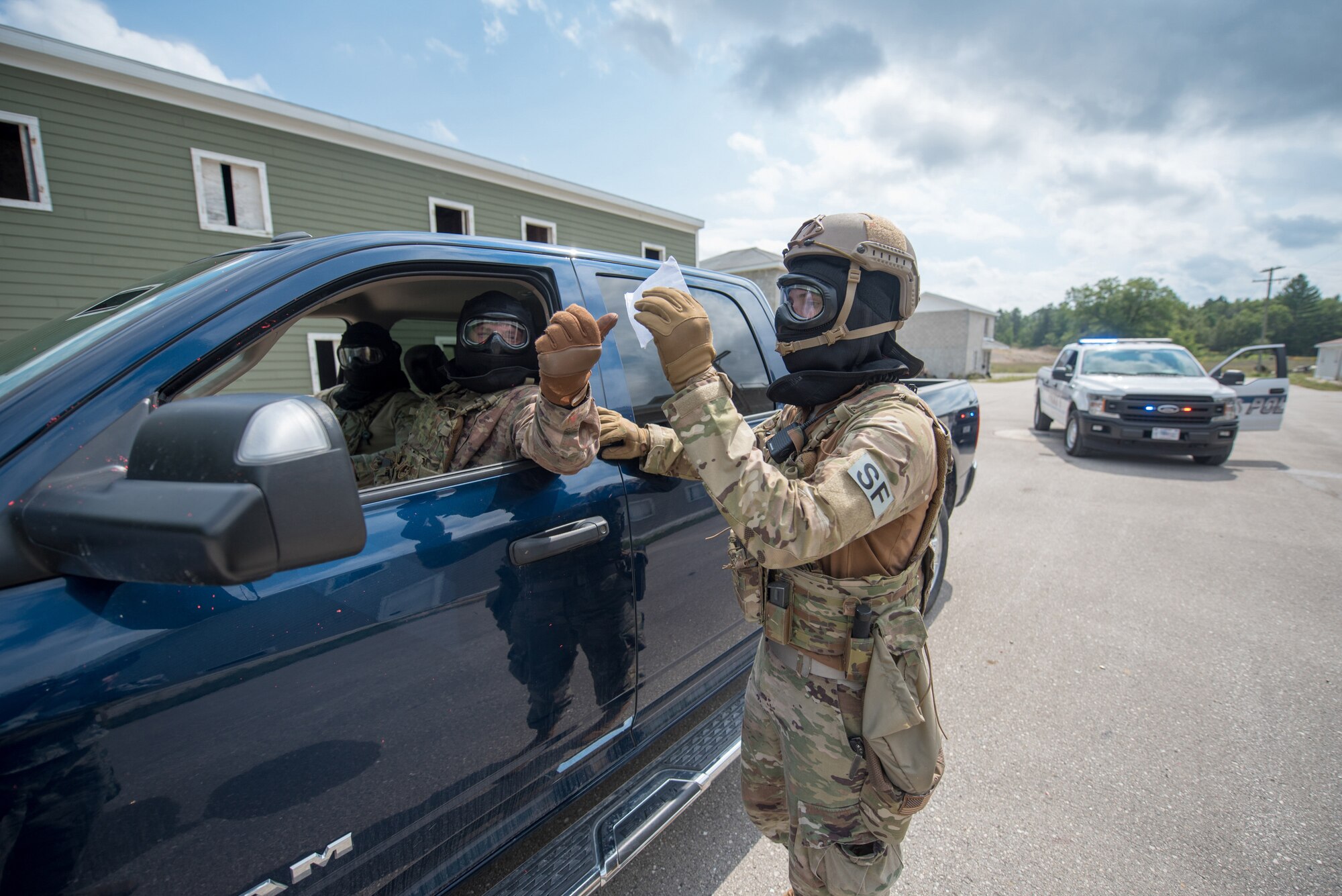 An Airman from the Kentucky Air National Guard’s 123rd Security Forces Squadron performs a simulated traffic stop during domestic operations training in Alpena, Mich., Aug 21, 2020. The Airmen spent a week at Alpena Combat Readiness Training Center to prepare them law enforcement assistance. (U.S. Air National Guard photo by Phil Speck)