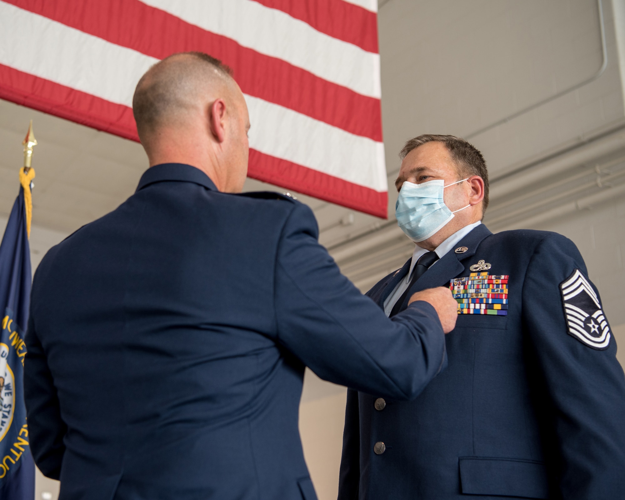 Chief Master Sgt. Robert Crump (right), outgoing equipment maintenance superintendent for the 123rd Maintenance Group, is pinned with the Meritorious Service Medal by Lt. Col. James Embry, commander of the 123rd Maintenance Group, during Crump’s retirement ceremony at the Kentucky Air National Guard Base in Louisville, Ky., Sept. 13, 2020. Crump is retiring after more than 39 years of service to the Kentucky Air National Guard. (U.S. Air National Guard photo by Staff Sgt. Joshua Horton)