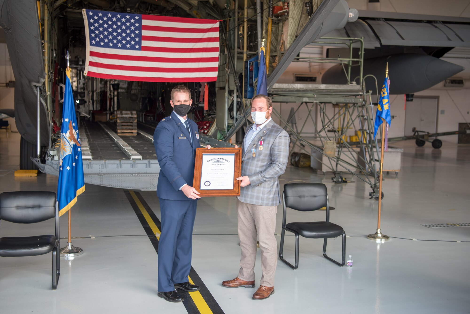 Maj. Joshua Jaburg (left), commander of the 123rd Force Support Squadron, presents the Kentucky Colonel Certificate to Chief Master Sgt. Larry Burba, chief enlisted manager for the 123rd Force Support Squadron and Explosive Ordinance Disposal flight, during Burba’s retirement ceremony at the Kentucky Air National Guard Base in Louisville, Ky., Oct. 17, 2020. Burba served for more than 21 years in the Kentucky Air National Guard. (U.S. Air National Guard photo by Phil Speck)