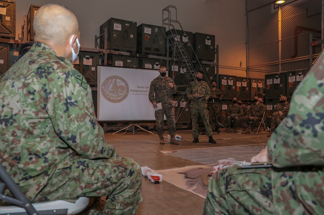 U.S. Marine Brig. Gen. Kyle B. Ellison, the commanding general of 3rd Marine Expeditionary Brigade gives opening remarks during a rehearsal of concept drill for Exercise Yama Sakura 79 at Camp Courtney, Okinawa, Japan, Dec. 5, 2020. Exercise Yama Sakura 79 provides opportunity for U.S. Marines and the Amphibious Rapid Deployment Brigade of the Japan Ground Self-Defense Force to conduct bilateral training and to share practices, techniques, and experience. The exercise shows the strength of the U.S.-Japan alliance, as well as to promote regional security in the Indo-Pacific Region. The U.S. and Japan are committed to executing bilateral exercises like YS 79 while safeguarding the local public and maintaining readiness at all times despite the pandemic. The 3D MEB is a resilient, ready and relevant force in the Indo-Pacific. Portions of this image were masked for security reasons. (U.S. Marine Corps photo by Cpl. Hannah Hall)