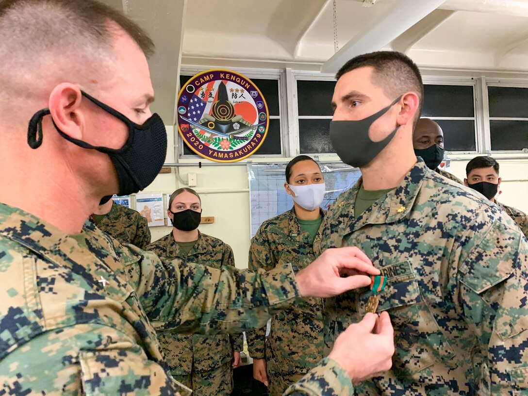 U.S. Marine Corps Brig. Gen. Kyle B. Ellison, commanding general of 3D Marine Expeditionary Brigade, recognizes and awards Marines involved in Exercise Yama Sakura 79 on Camp Courtney, Okinawa, Japan, Dec. 13, 2020. YS 79 allows Marines, and their Japanese counterparts to maintain their interoperability, and readiness to respond to any crisis or contingency in the Indo-Pacific region. (U.S. Marine Corps photo by Maj. Caleb Eames)