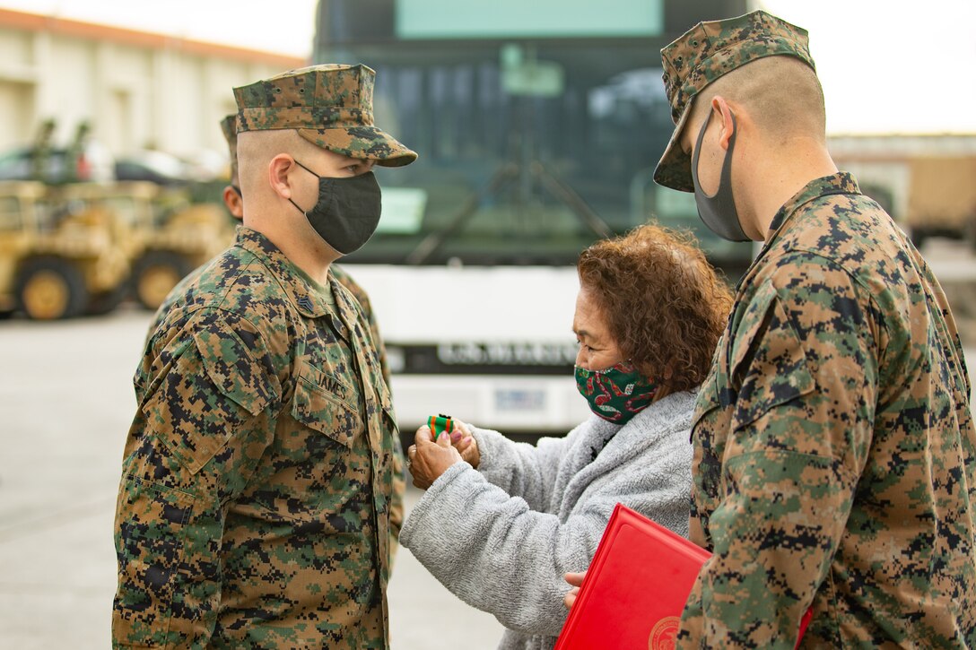 Sgt. John James, a motor vehicle operator with Combat Logistics Battalion 31, 31st Marine Expeditionary Unit (MEU), is awarded the Navy Achievement Medal for saving Tokiko Ahuso, a local Kin Town resident who was bitten by a habu viper on Nov. 6, at Camp Hansen, Okinawa, Japan, Dec 23, 2020. The 31st MEU, the Marine Corps’ only continuously forward-deployed MEU, provides a flexible and lethal force ready to perform a wide range of military operations as the premier crisis response force in the Indo-Pacific region. (U.S. Marine Corps photo by Cpl. Brandon Salas)