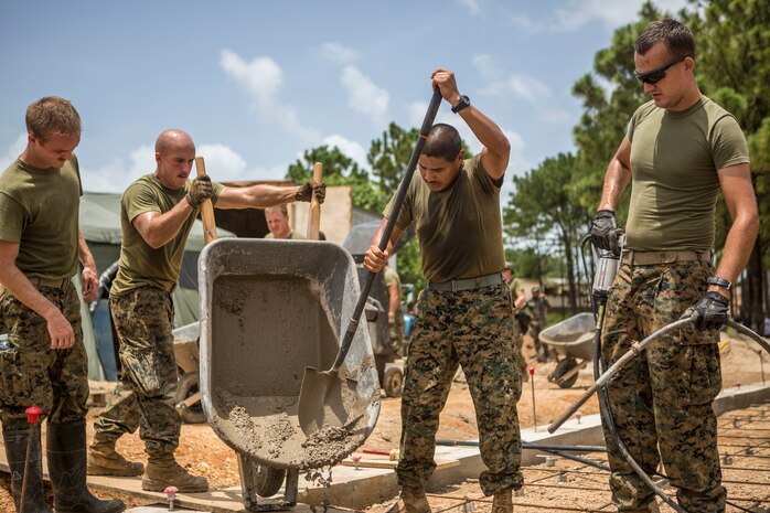 U.S. Marines work together to pour cement into the foundation of the Republica de Cuba School in Puerto Lempira, Honduras, Aug. 17.