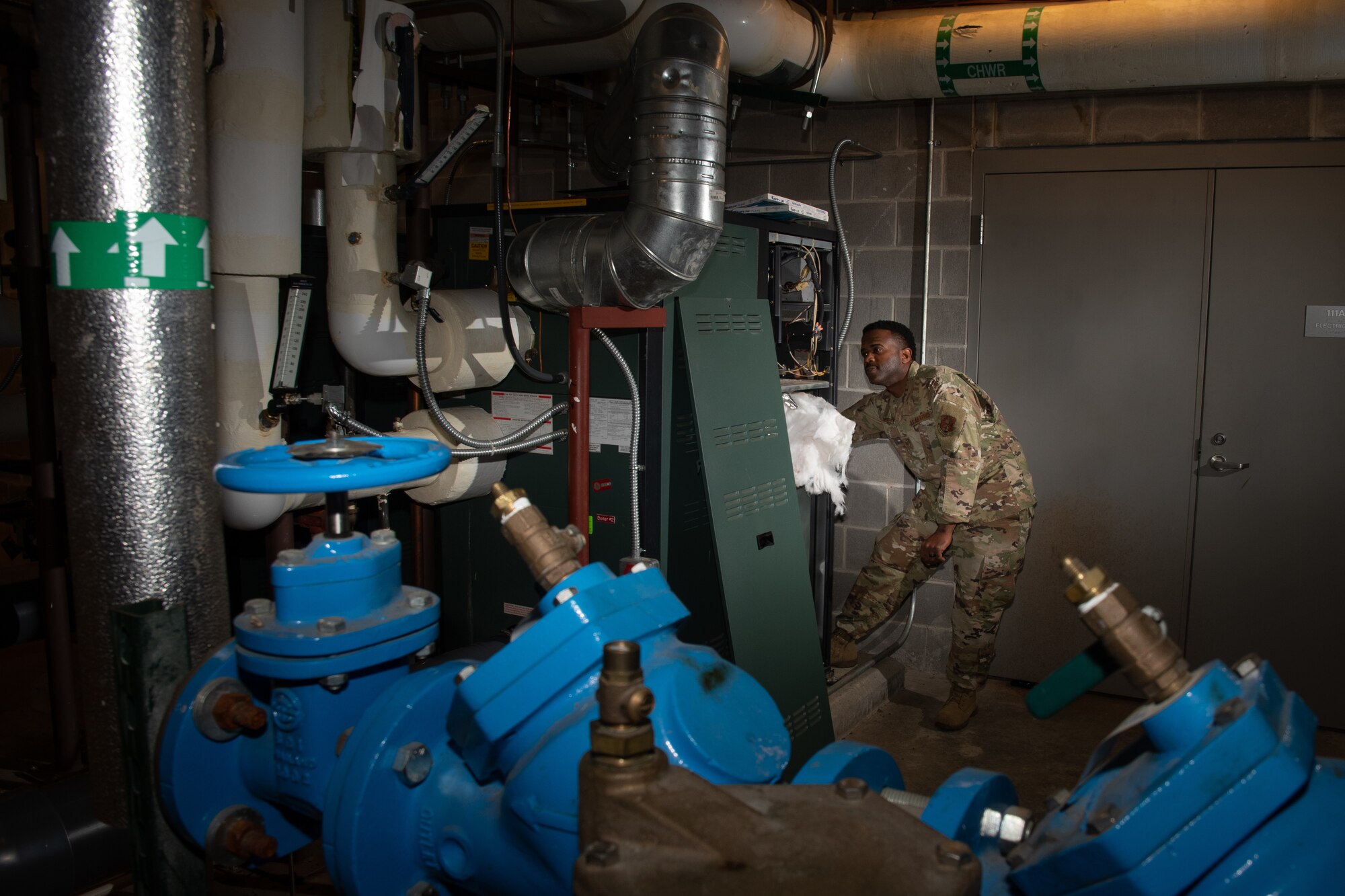 U.S. Air Force Staff Sgt. Travis Shelley, a heating, ventilation, and air conditioning technician with the 116th Civil Engineer Squadron, 116th Air Control Wing, Georgia Air National Guard, performs a periodic inspection on a boiler at Robins Air Force Base, Georgia, Dec. 30, 2020. Shelley was the recipient of the Major General Eugene A. Lupia Award in the Airman category for the Air National Guard in 2020 for superior job performance. (U.S. Air National Guard photo by Senior Master Sgt. Roger Parsons)