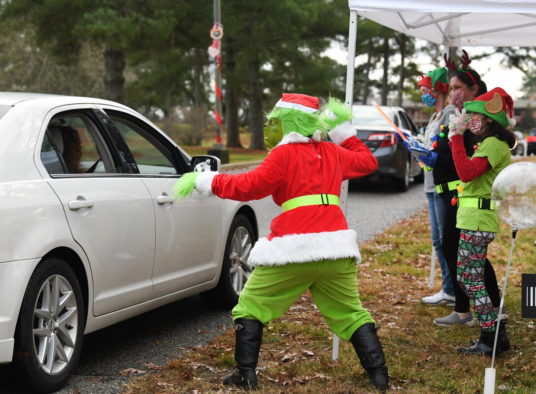 The Grinch pretends to throw a snowball at attendees of the Children's Candy Cane Caravan at Arnold Air Force Base, Tenn., Dec. 12, 2020. The event replaced the traditional Children's Christmas Party because of the need for social distancing due to the COVID-19 pandemic. (U.S. Air Force photo by Jill Pickett)