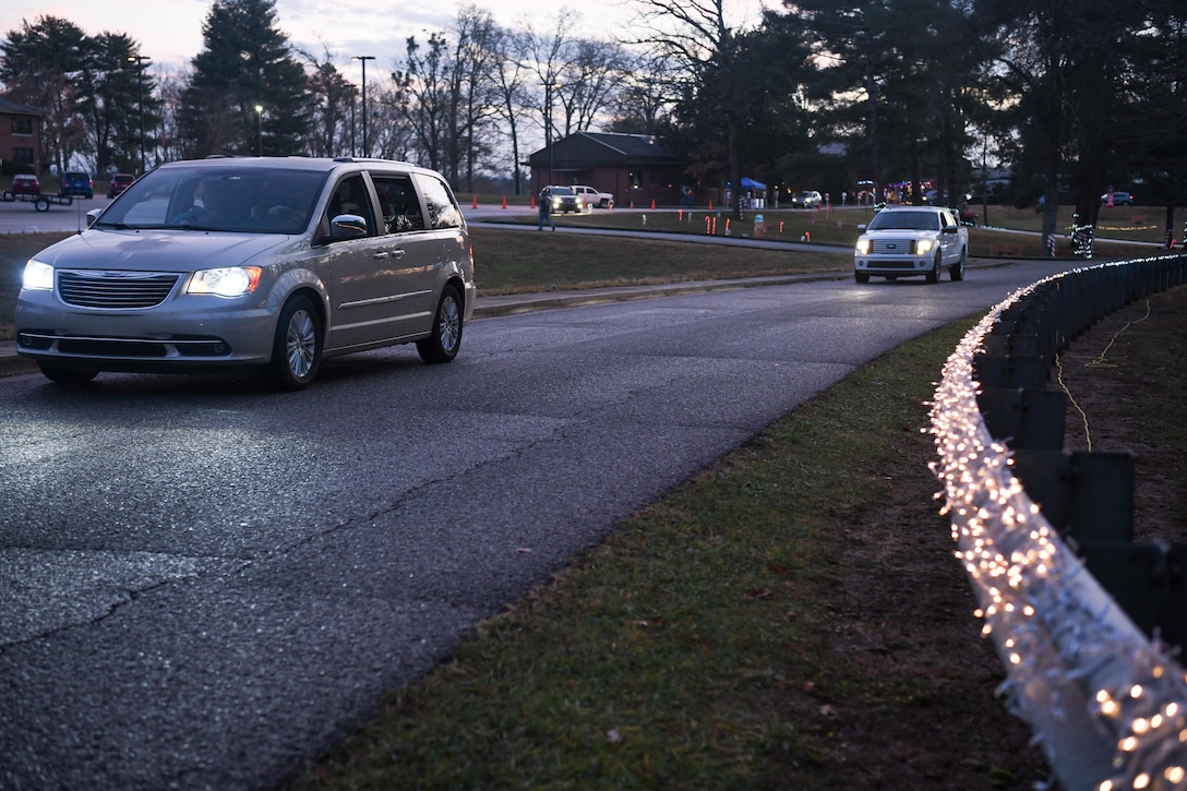 Vehicles pass by Christmas lights, Dec. 12, 2020, during the Children's Candy Cane Caravan at Arnold Air Force Base, Tenn. The event was a drive-thru event to minimize contact between staff and guests because of the COVID-19 pandemic. (U.S. Air Force photo by Jill Pickett)