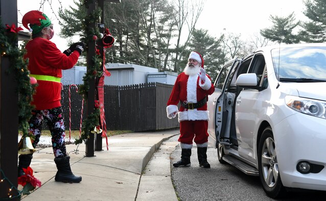 Santa Claus poses for a photo with children, Dec. 12, 2020, during the Children's Candy Cane Caravan at Arnold Air Force Base, Tenn. Attendees of the event stayed in their vehicles during the event to maintain social distancing and minimize risks associated with the COVID-19 pandemic. (U.S. Air Force photo by Jill Pickett)