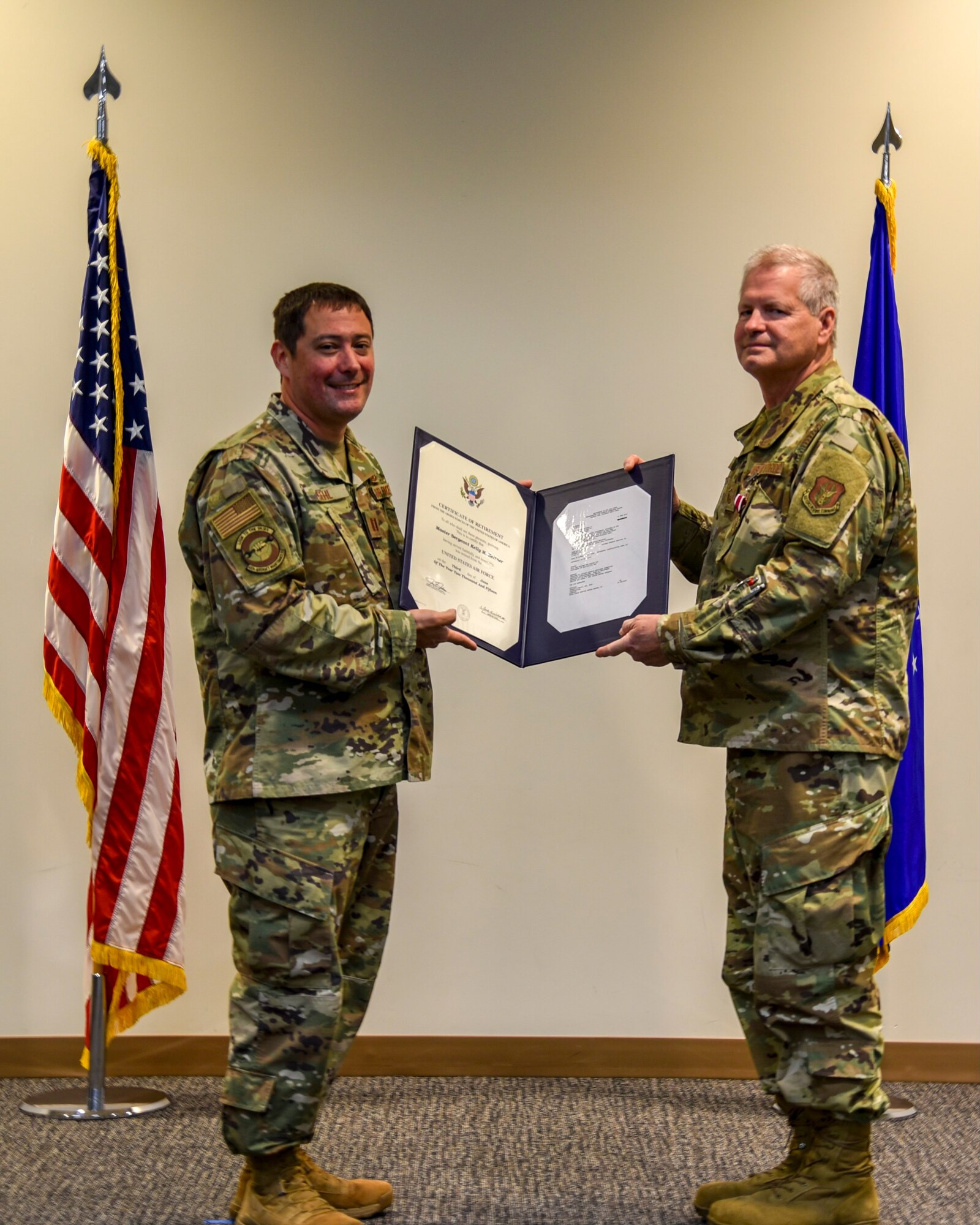 Capt. Anthony Gehl of the 403rd Aircraft Maintenance Squadron, presents Master Sgt. James Rials with his certificate of retirement at the Roberts Consolidated Maintenance Facility Dec. 6, 2020. Rials retired after serving nearly 40 years, all with the Air Force Reserve's 403rd Wing at Keesler Air Force Base (Courtesy photo).