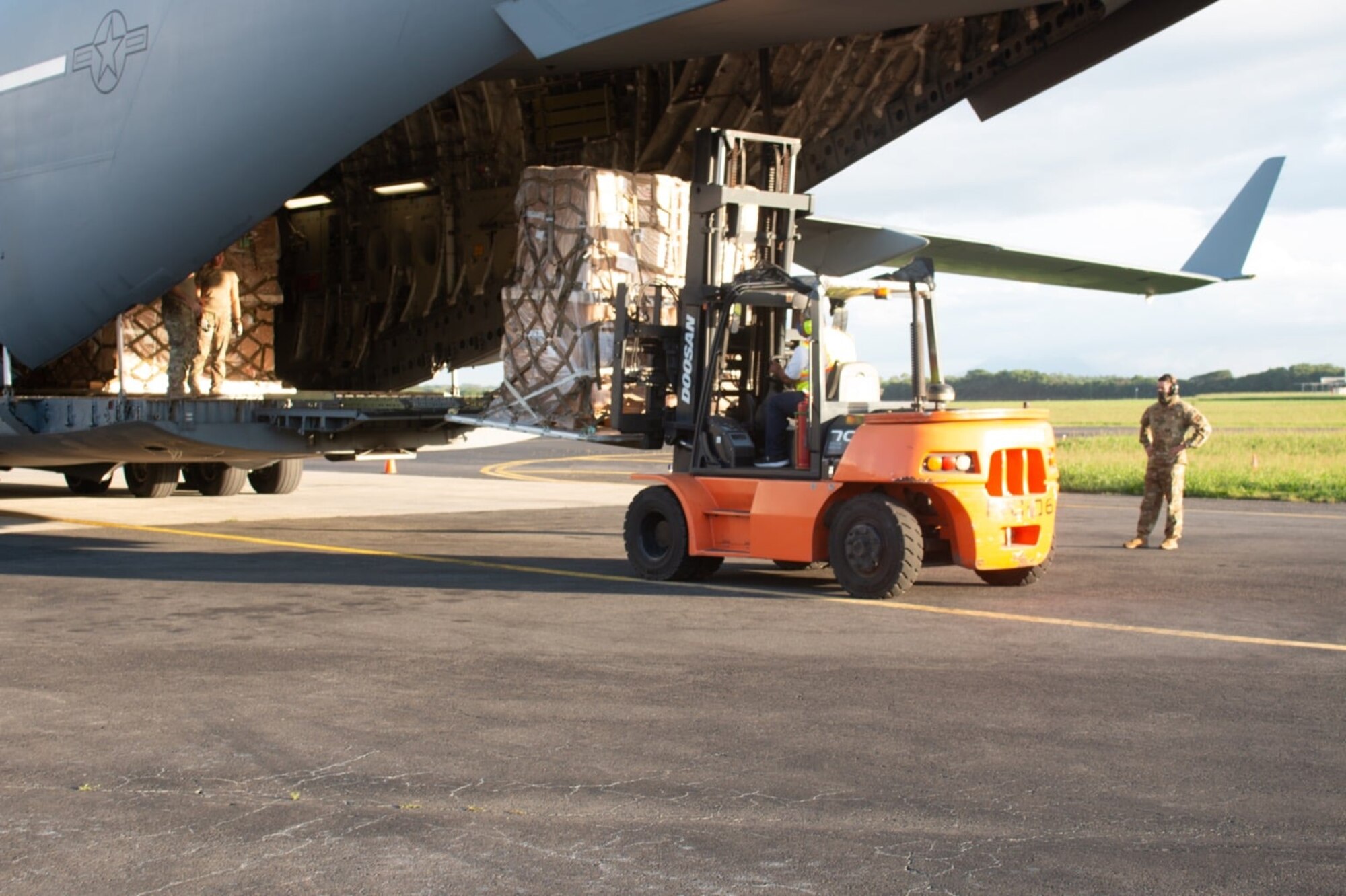 A C-17 Globemaster III loadmaster assigned to the 313th Airlift Squadron at Joint Base Lewis-McChord, Wash., helps offload educational resources in Nicaragua Nov. 22, 2020.