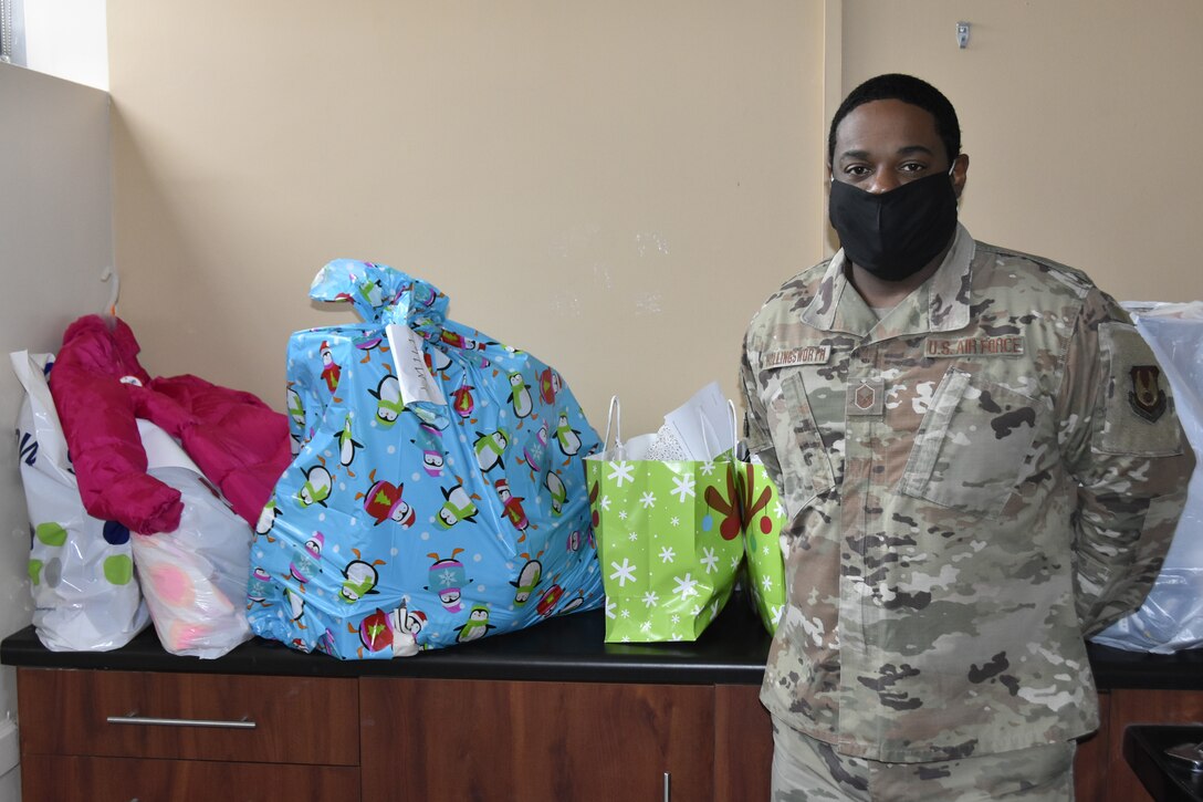 Master Sgt. Ricardo Hollingsworth stands with some of the gifts provided to area children by members of the Arnold Air Force Base workforce through the Arnold Engineering Development Complex Angel Tree program. This year, more than 200 children in surrounding counties were sponsored through the AEDC program. (U.S. Air Force photo by Bradley Hicks)