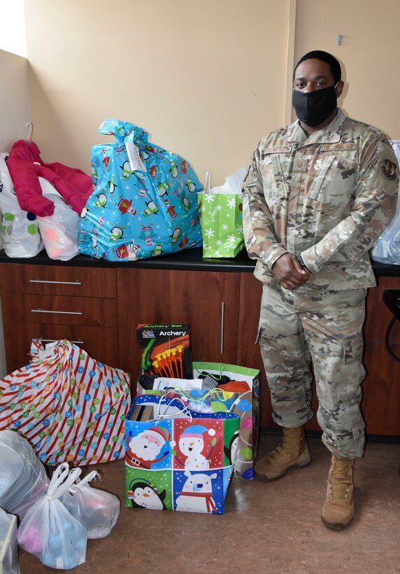 Master Sgt. Ricardo Hollingsworth stands with some of the gifts provided to area children by members of the Arnold Air Force Base workforce through the Arnold Engineering Development Complex Angel Tree program. This year, more than 200 children in surrounding counties were sponsored through the AEDC program. (U.S. Air Force photo by Bradley Hicks)