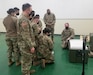 Sgt. Grider Gossett, right, with the 95th Medical Detachment-Blood Support, teaches members of the 563rd Medical Logistics Company at the U.S. Army Medical Materiel Center-Korea how to operate specialized mobile freezers needed to safely transport doses of the Moderna COVID-19 vaccine for distribution to U.S. Forces Korea.