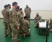 Sgt. Grider Gossett, right, with the 95th Medical Detachment-Blood Support, teaches members of the 563rd Medical Logistics Company at the U.S. Army Medical Materiel Center-Korea how to operate specialized mobile freezers needed to safely transport doses of the Moderna COVID-19 vaccine for distribution to U.S. Forces Korea.